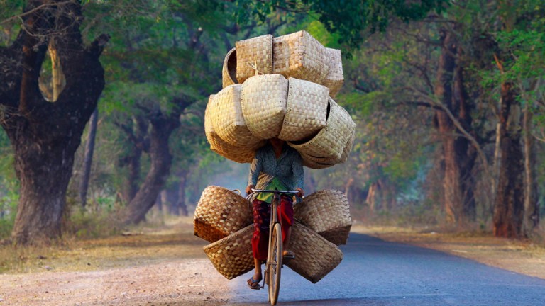 Woman on bicycle with baskets