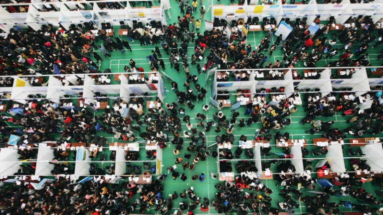 Job seekers attend a job fair at Tianjin University November 22, 2013. According to local media, more than 6,000 people rushed to the job fair on Friday for openings from 300 companies against the backdrop that a decrease is expected in available positions for fresh graduates in the China job market in 2014.